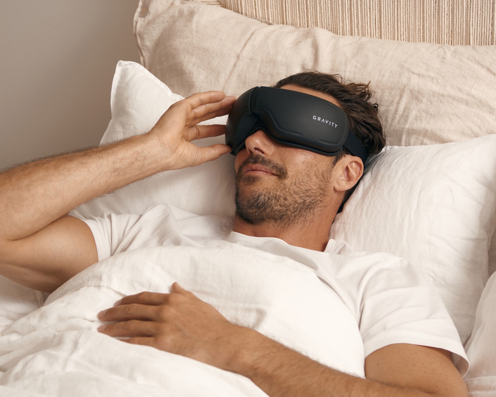 Person wearing the Gravity Eye Massager in bed